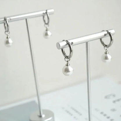 Geometric round pearl drop earrings for women with alloy metal and titanium steel posts.