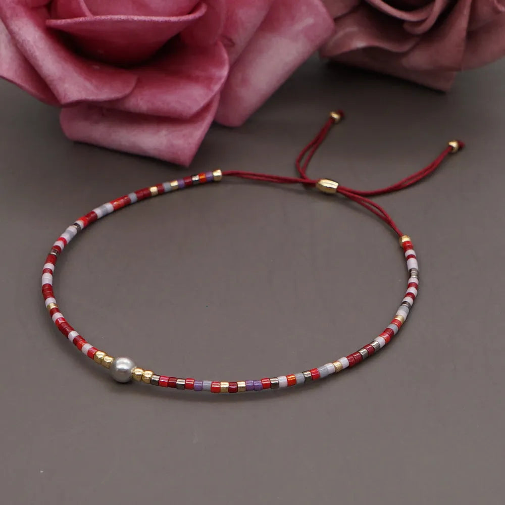 Handmade women's bracelet with colourful geometric glass and coloured glaze beads in Bohemian style.