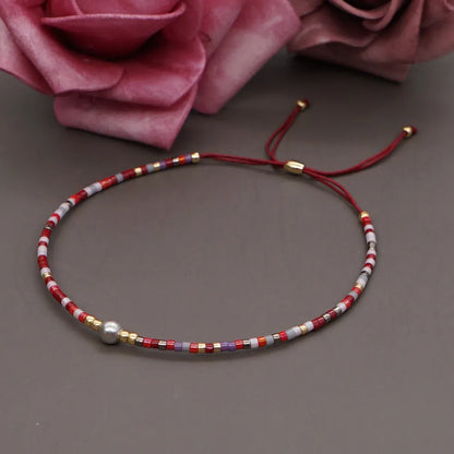 Handmade women's bracelet with colourful geometric glass and coloured glaze beads in Bohemian style.