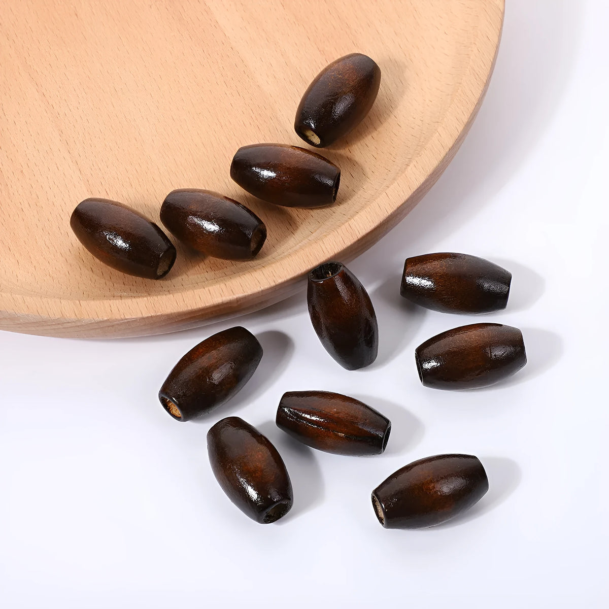 Dark coffee coloured oval wooden beads with M-shaped design, 25mm size with 6mm hole
