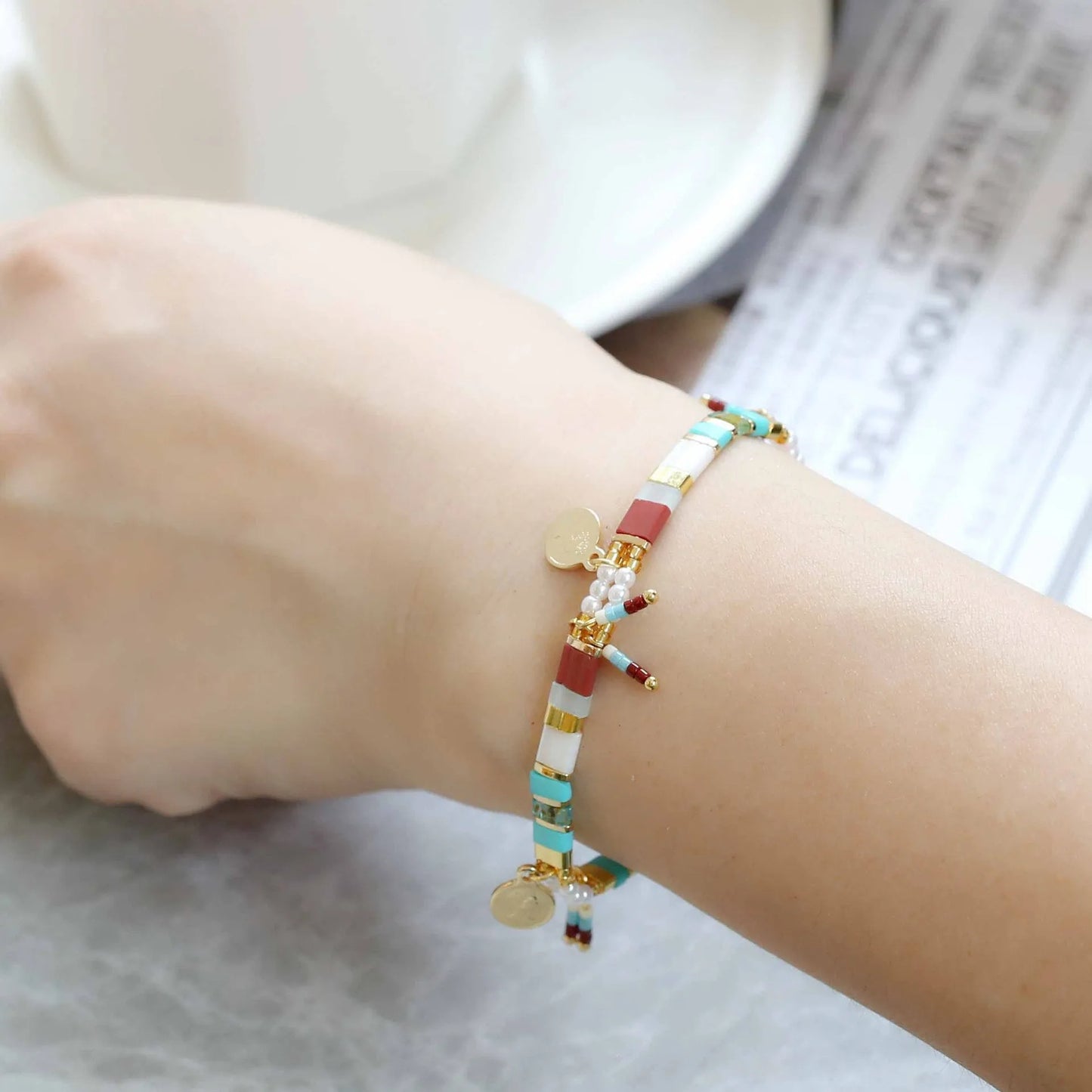Women's handcrafted bracelet with imitation pearl and coloured glass beads in one of six colour styles.