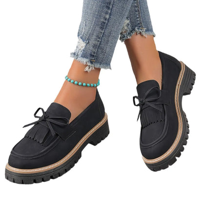 Women's black plus size loafers with tassel, bowknot, chunky heel, and rubber sole