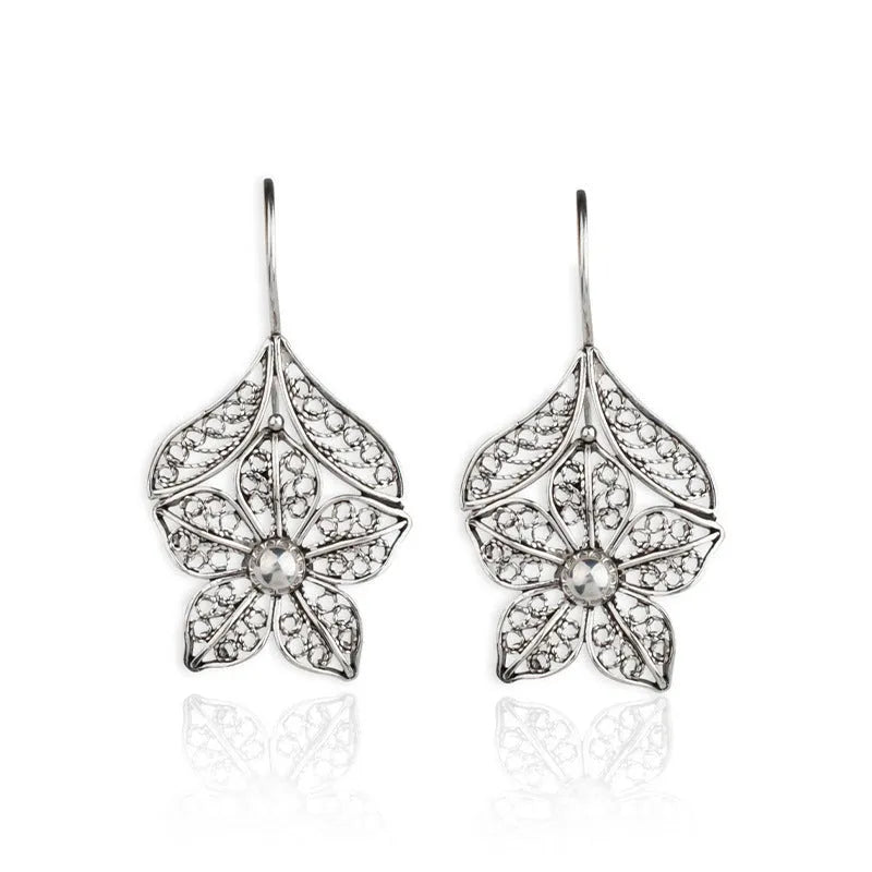 Silver hollow flower leaf-shaped alloy earrings with openwork floral detailing