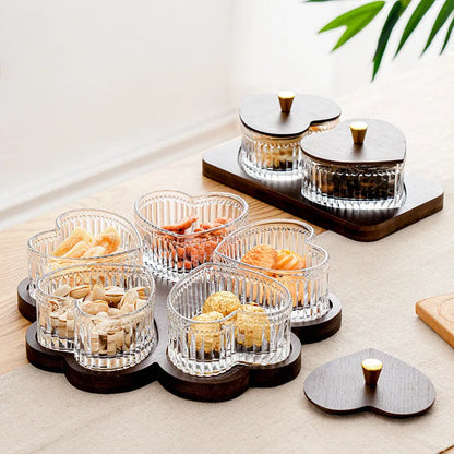 Glass dim sum fruit platter with coloured glaze and a transparent heart-shaped lid on a multi-grid tray.