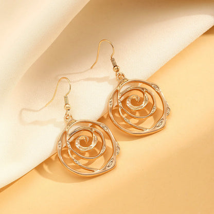 Gold spiral donut alloy jewellery set showing necklace, bracelet, and ear hooks on a plain background.