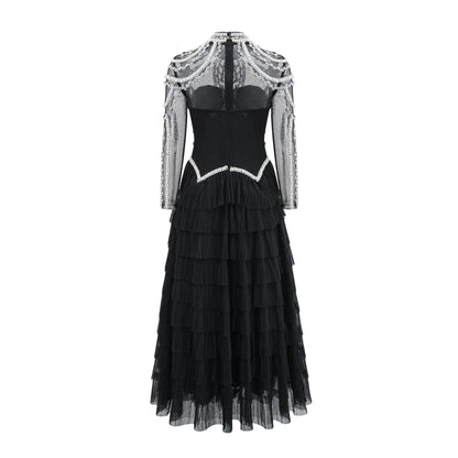 Women's long sleeve black beaded dress with 3D decoration and a mid waist.