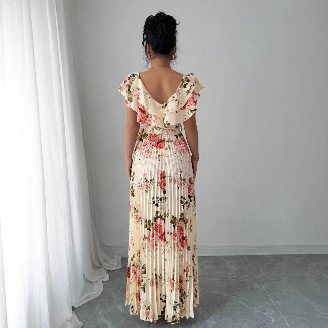 Apricot-coloured V-neck dress with floral print, ruffled short sleeves, high waist, and a long, pleated swing skirt.