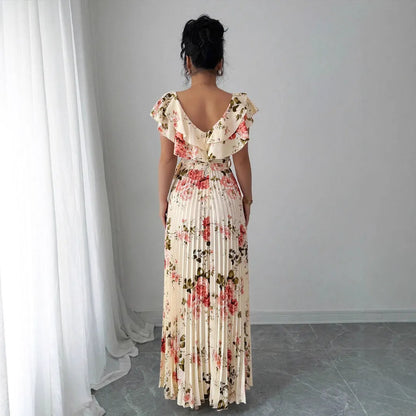Apricot-coloured V-neck dress with floral print, ruffled short sleeves, high waist, and a long, pleated swing skirt.