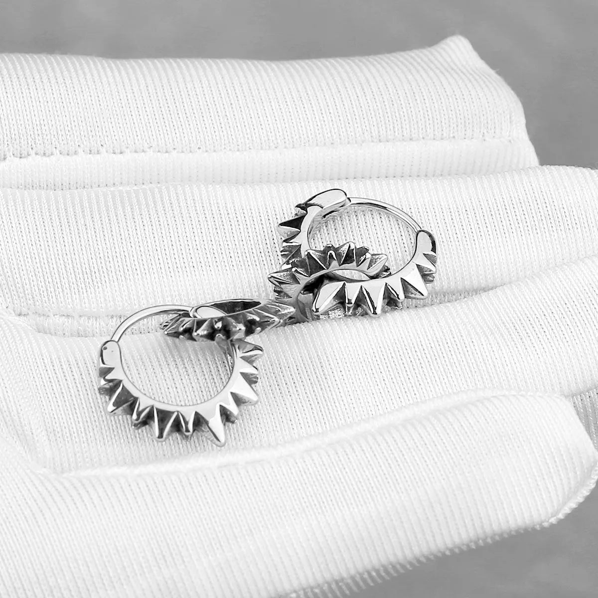 Simple round stainless steel hoop earrings with a polished finish, shown on a plain background.