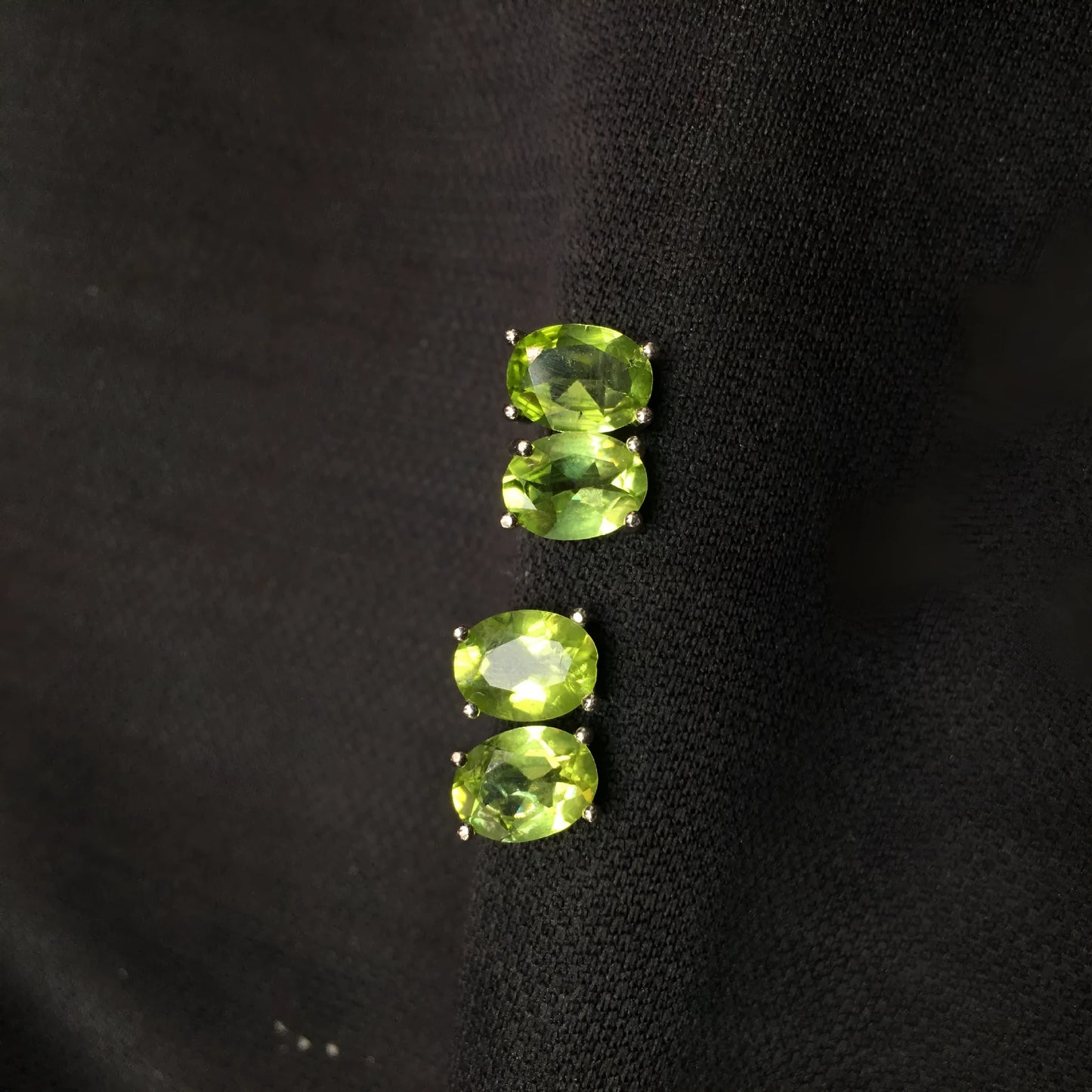 Close-up of grass green natural olivine stud earrings with geometric cut on S925 silver posts