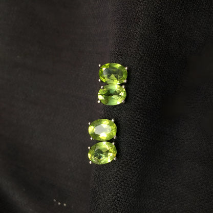 Close-up of grass green natural olivine stud earrings with geometric cut on S925 silver posts