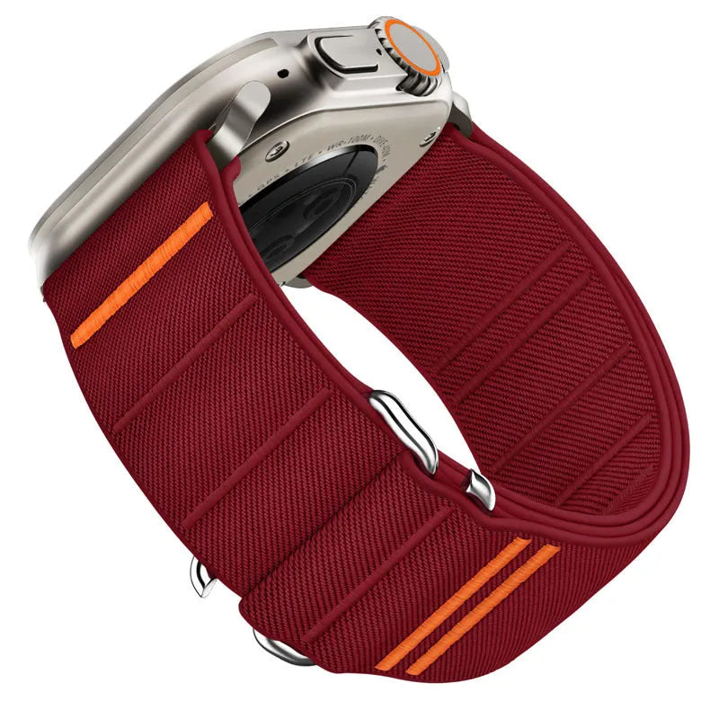 Elastic nylon Apple Watch band in Army Green with stainless steel buckle, shown on a wrist.