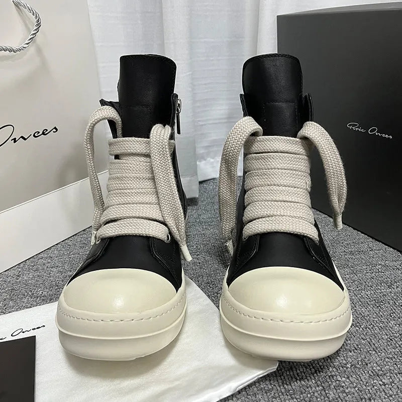 Black high-top leather sneakers with side zipper, round toe, and stitching details on genuine cowhide upper