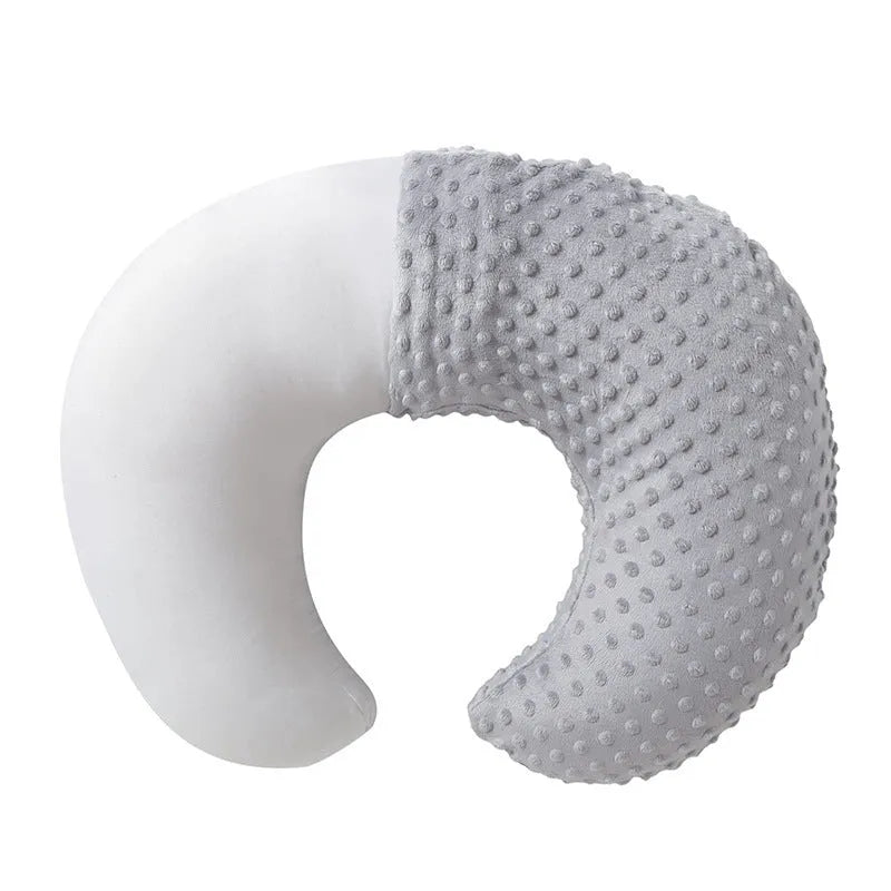 Nursing pillow with integrated 15cm raised barrier to prevent milk spills during breastfeeding, shown with removable pillowcase