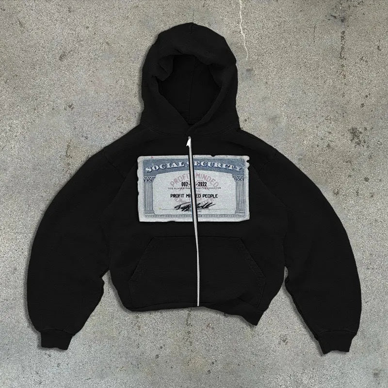 A person wearing a black loose-fit zip-up hoodie with a hood and front pockets.