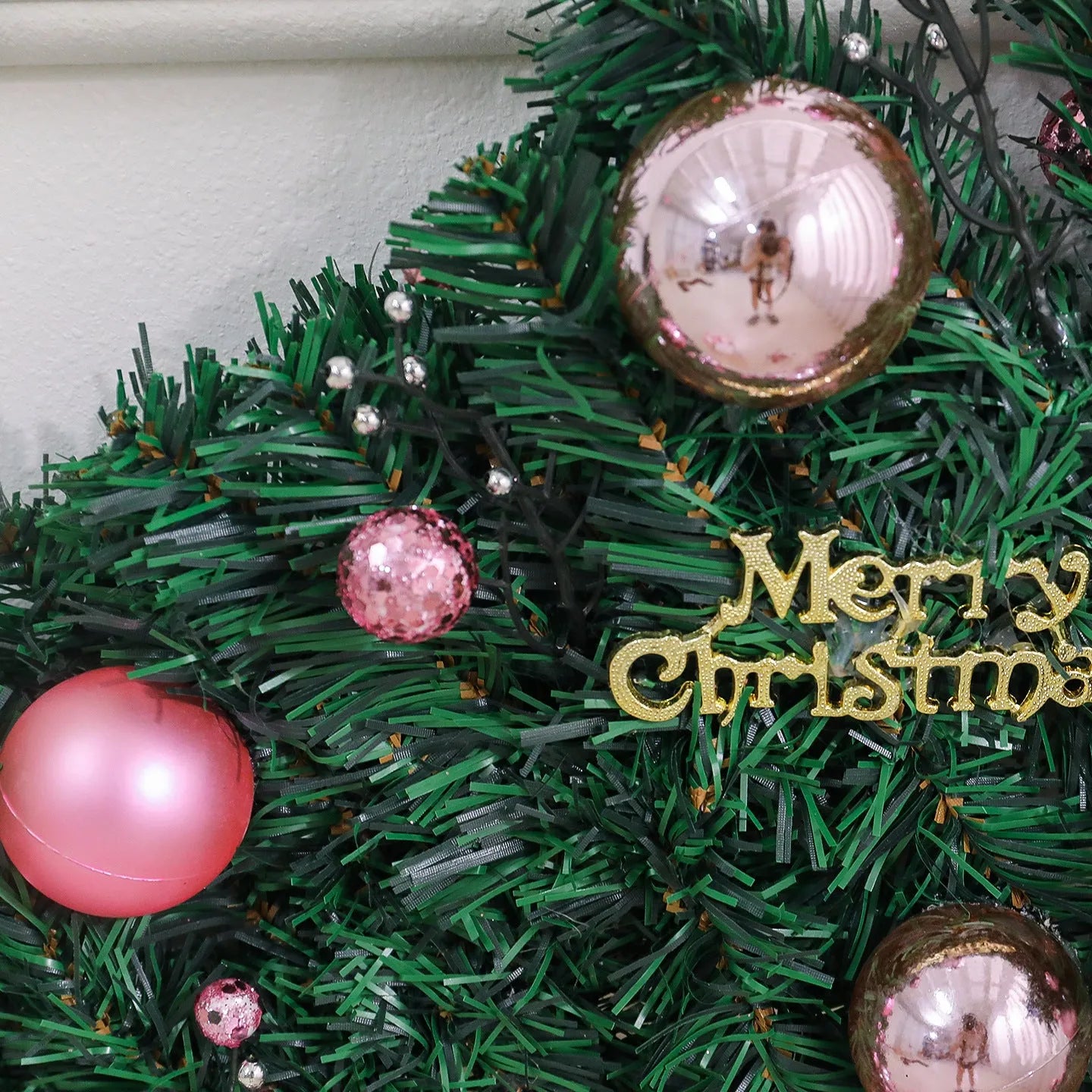 2.7 metre pink artificial rattan Christmas garland with 240 PVC foliage heads and optional coloured lighting