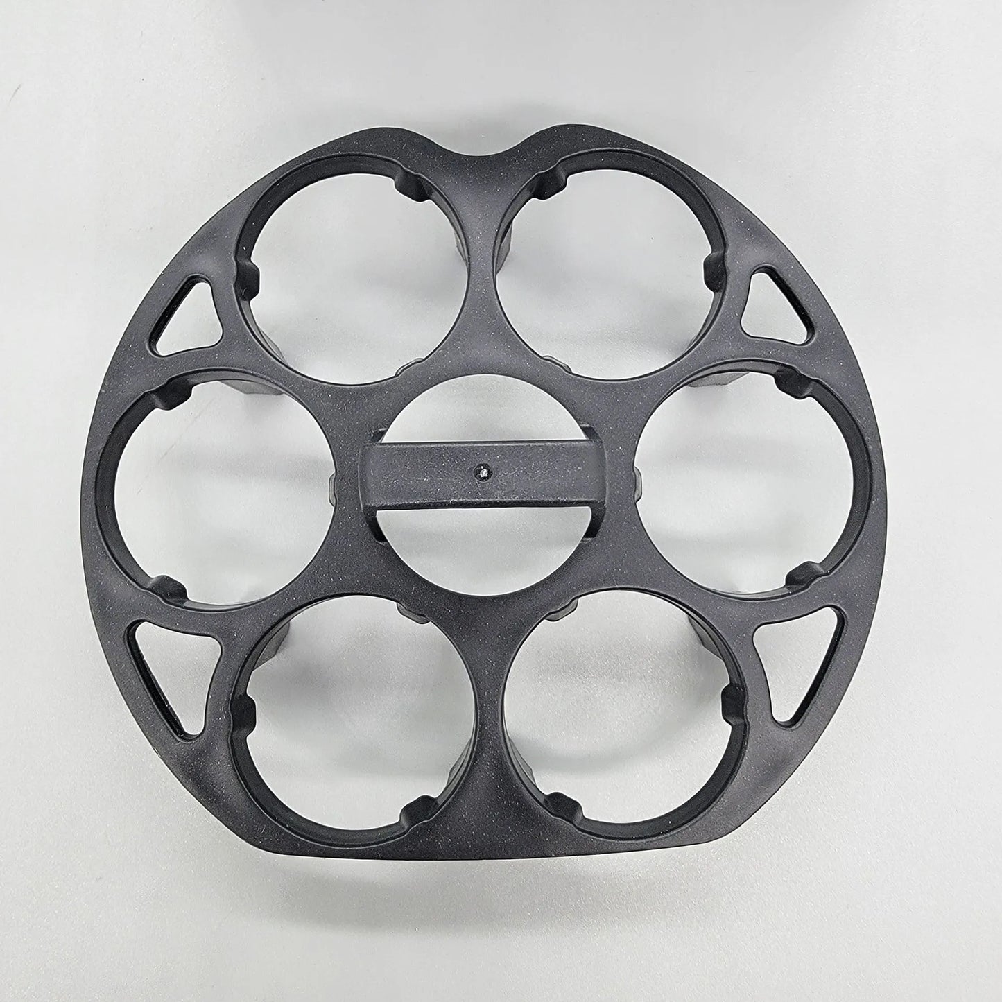 Black plastic egg holder rack for a cooking machine, shown from above.