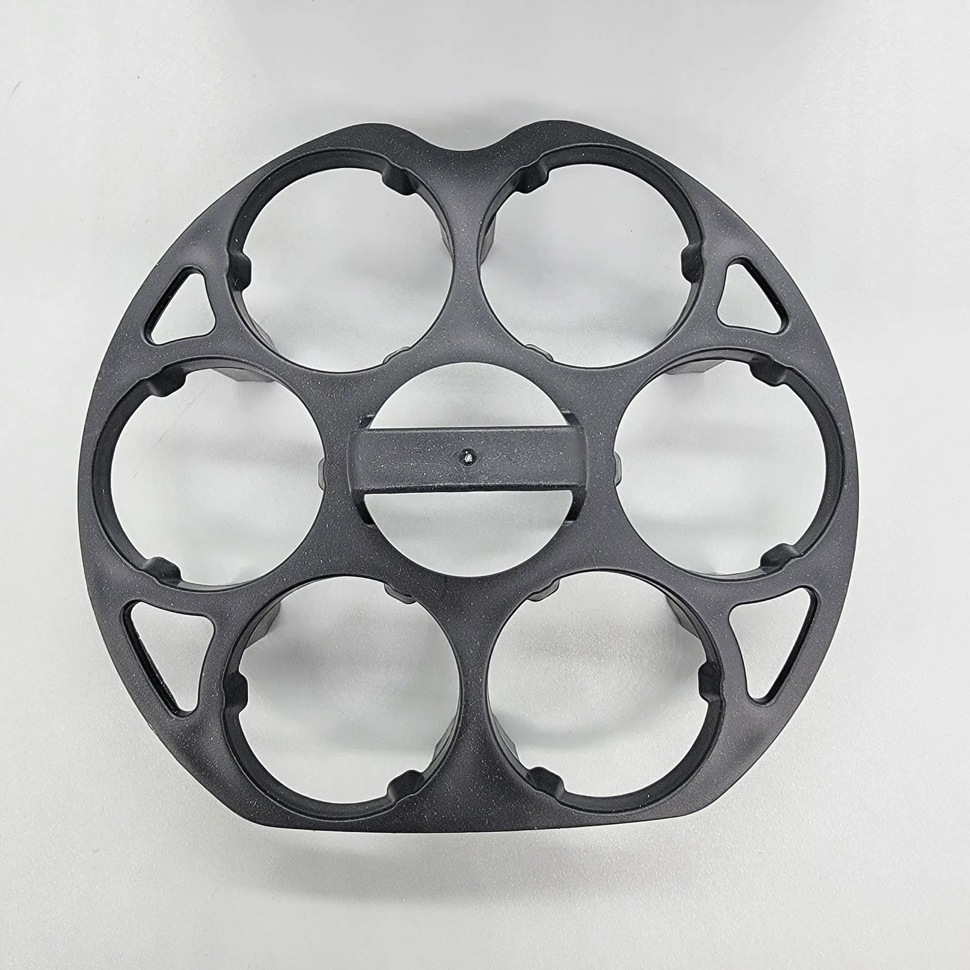 Black plastic egg holder rack for a cooking machine, shown from above.
