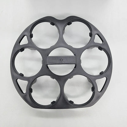 Black plastic egg holder rack for a cooking machine, shown from above.