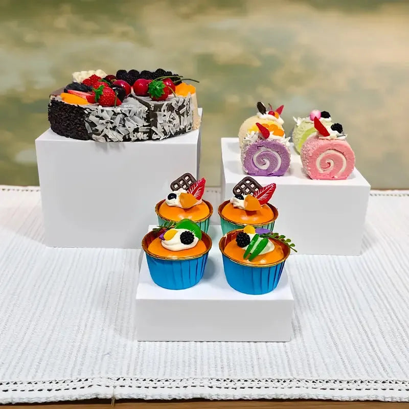 Six acrylic cubes in graduated sizes 3-8cm for dessert display, available in transparent or white
