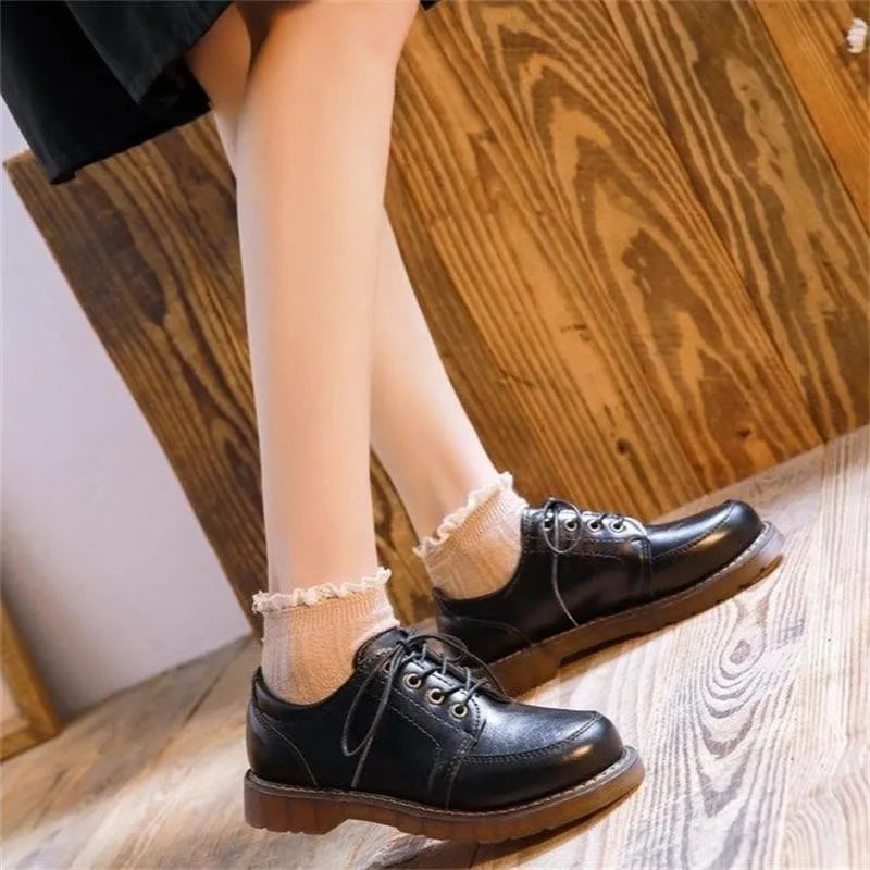Black retro women's Mary Jane pumps with a low square heel and front lace-up.