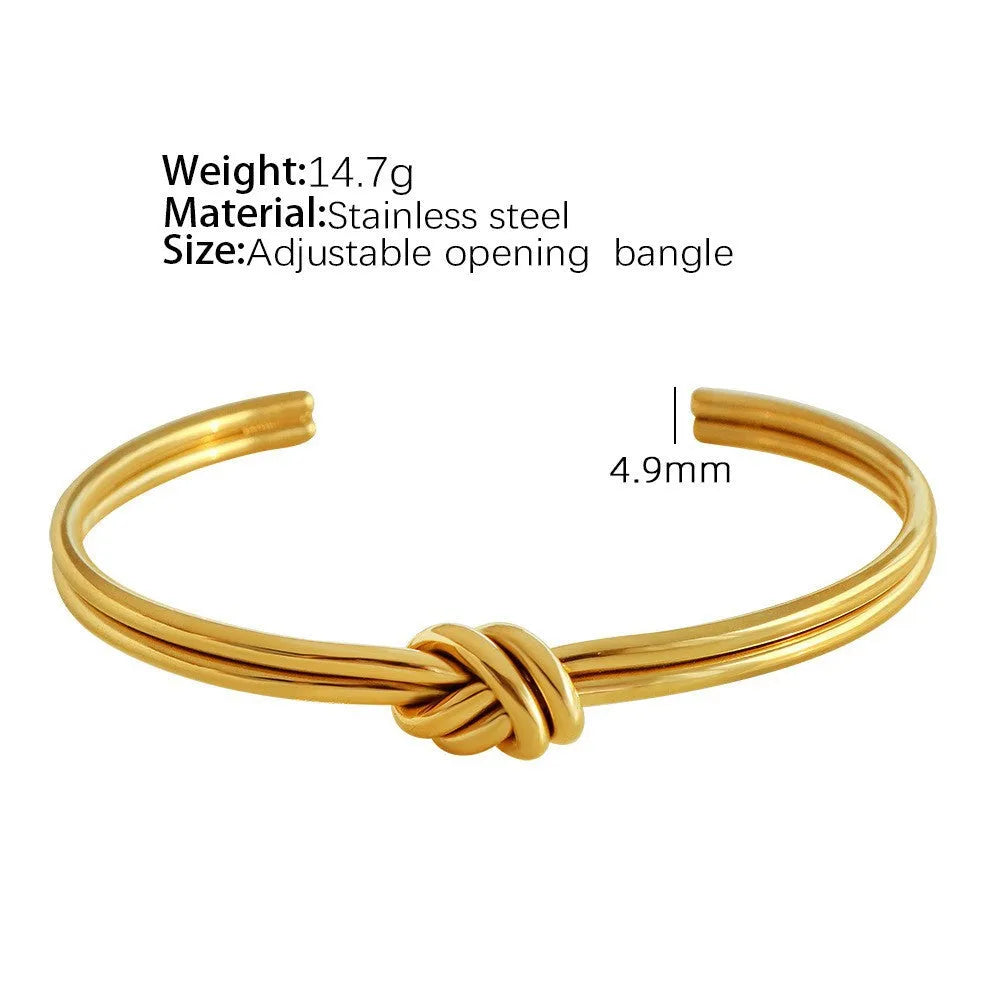 Women's knotted C-shaped open double-layer stainless steel bracelet with gold plating.