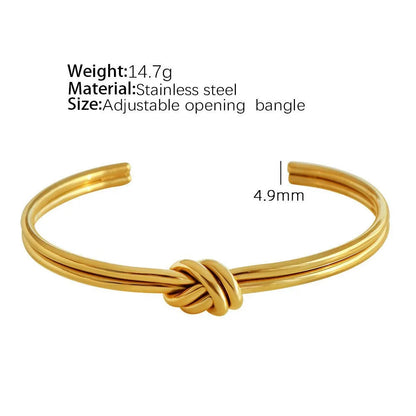 Women's knotted C-shaped open double-layer stainless steel bracelet with gold plating.