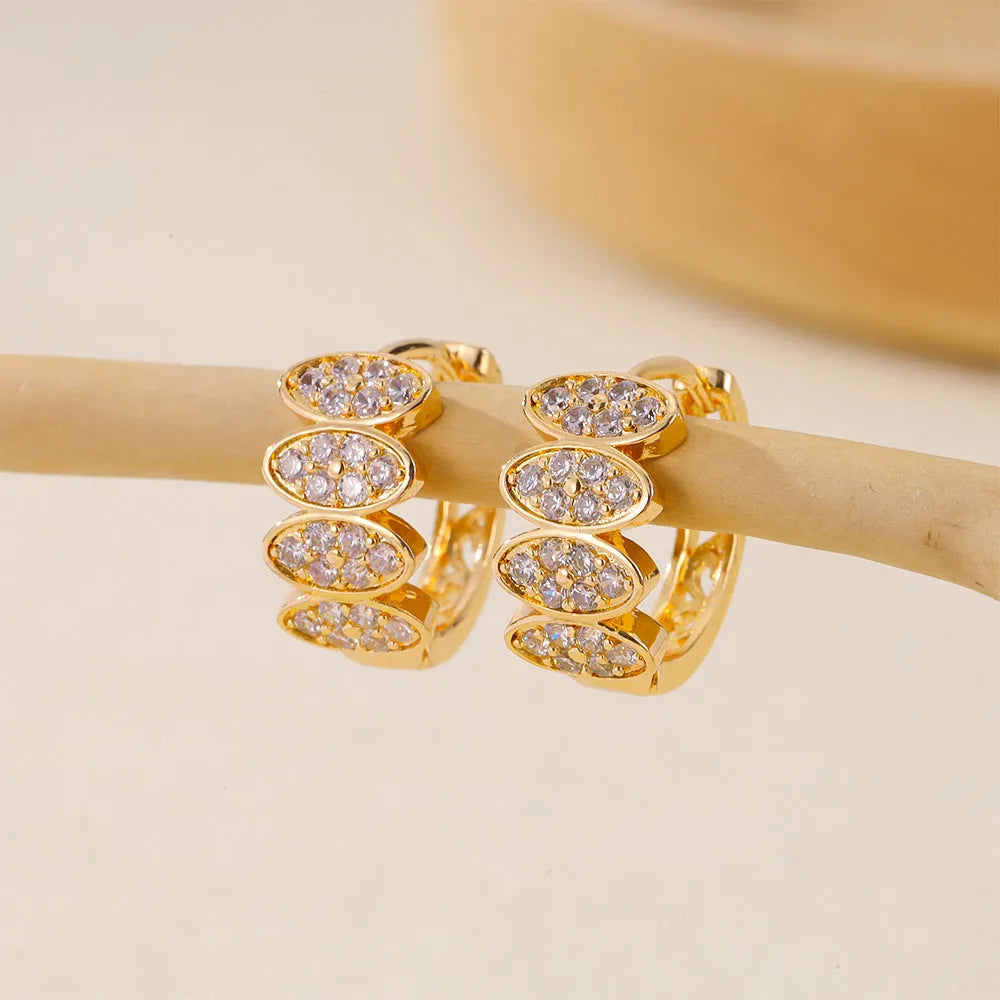 Women's gold colour ear rings with zircon stone mosaic detailing on copper construction