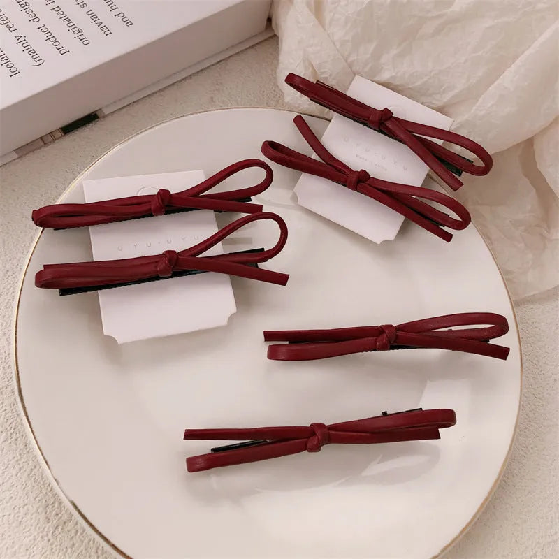 Wine red leather bow hair barrette with 2.5cm bow width and 5cm clip length