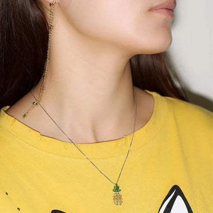 Geometric pineapple pendant necklace with silver and copper white gold plated finish on model
