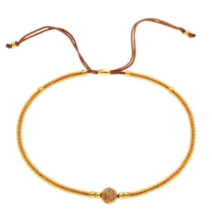 Handmade women's bracelet with colourful geometric glass and coloured glaze beads in Bohemian style.