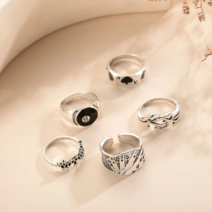 Adjustable black alloy ring with a large raised poker spade motif on a finger.