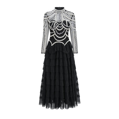 Women's long sleeve black beaded dress with 3D decoration and a mid waist.