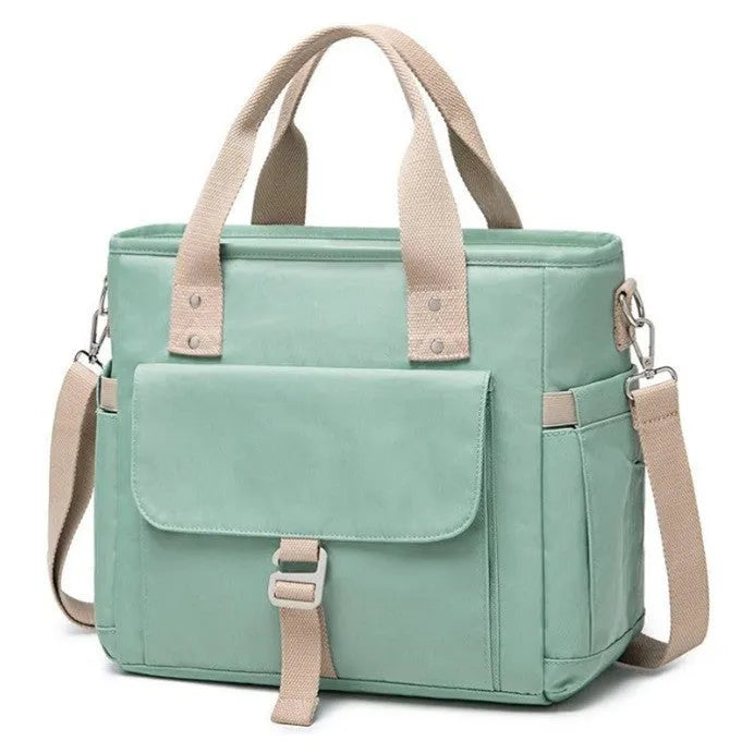 Insulated cube-shaped picnic bag with a removable shoulder strap in pink, shown with a side pocket.