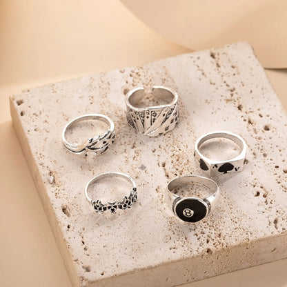 Adjustable black alloy ring with a large raised poker spade motif on a finger.