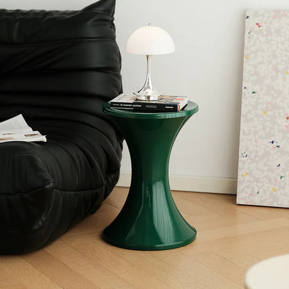 Plastic hourglass-shaped shoe changing stool in green, 40cm high and 30cm wide