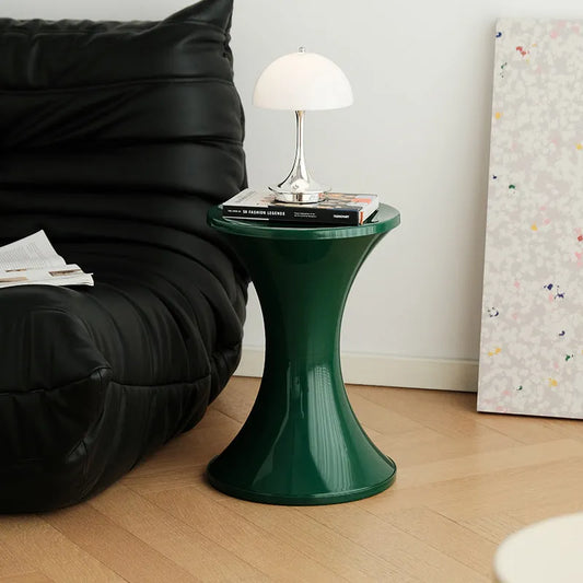 Plastic hourglass-shaped shoe changing stool in green, 40cm high and 30cm wide