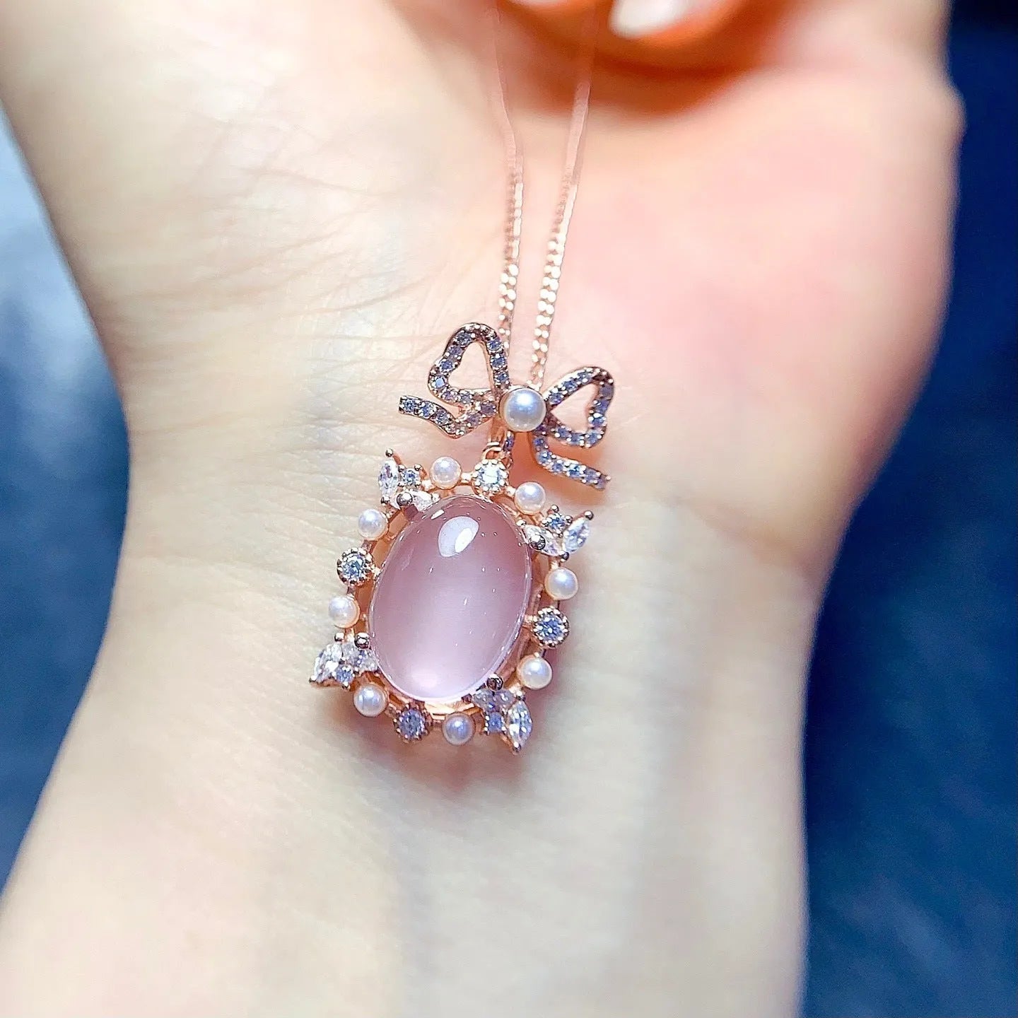 Geometric rose quartz pendant necklace on sterling silver chain with rose gold plating.