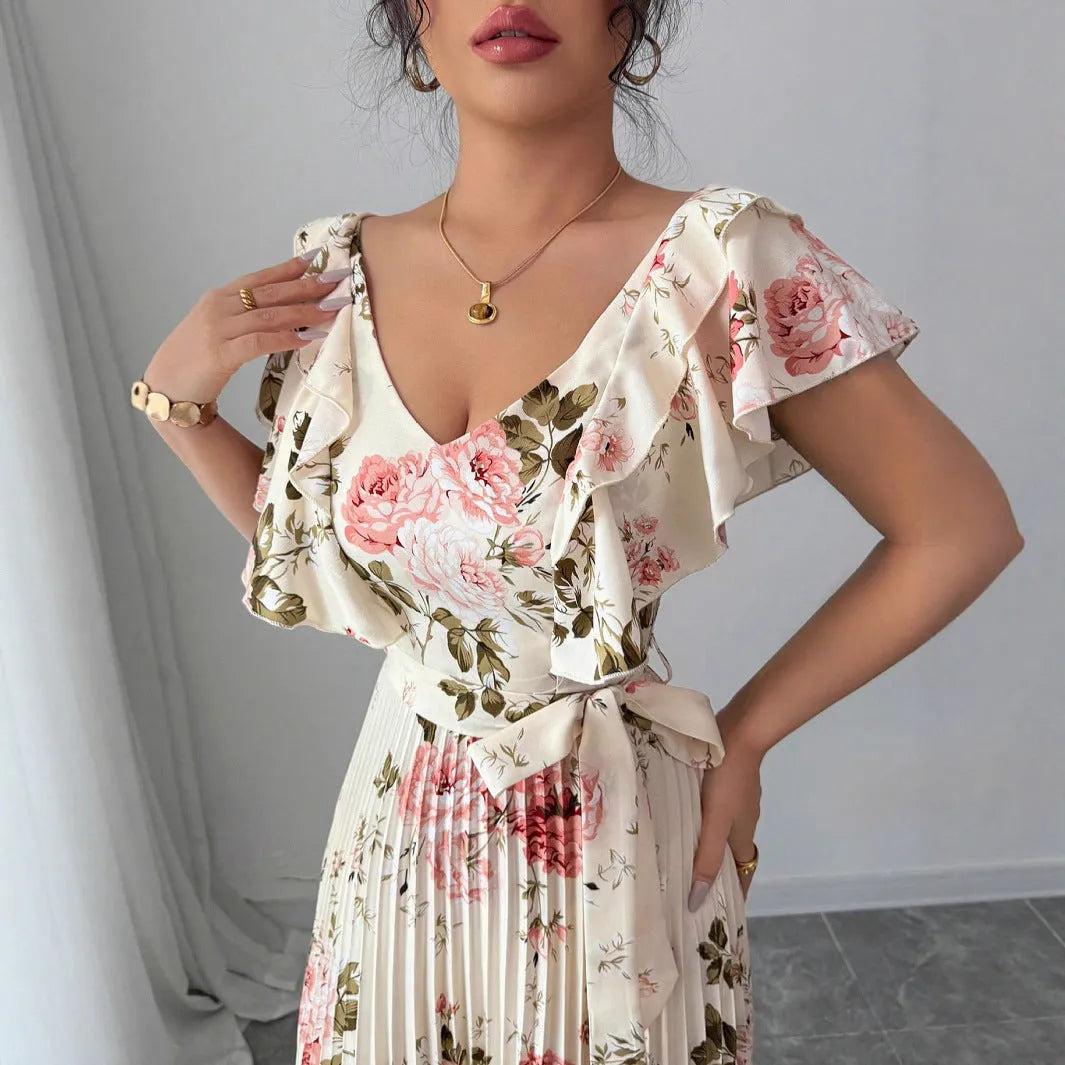 Apricot-coloured V-neck dress with floral print, ruffled short sleeves, high waist, and a long, pleated swing skirt.