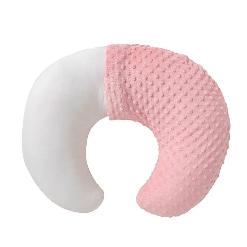 Nursing pillow with integrated 15cm raised barrier to prevent milk spills during breastfeeding, shown with removable pillowcase