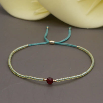 Handmade women's bracelet with colourful geometric glass and coloured glaze beads in Bohemian style.