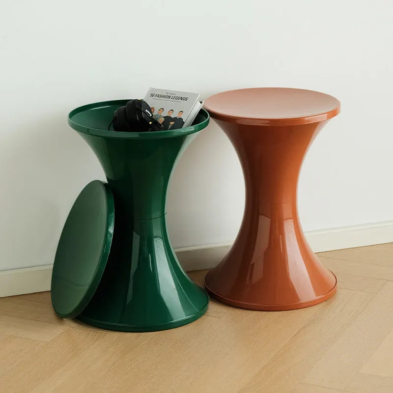 Plastic hourglass-shaped shoe changing stool in green, 40cm high and 30cm wide