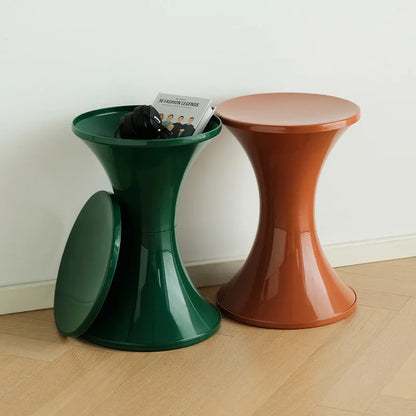 Plastic hourglass-shaped shoe changing stool in green, 40cm high and 30cm wide