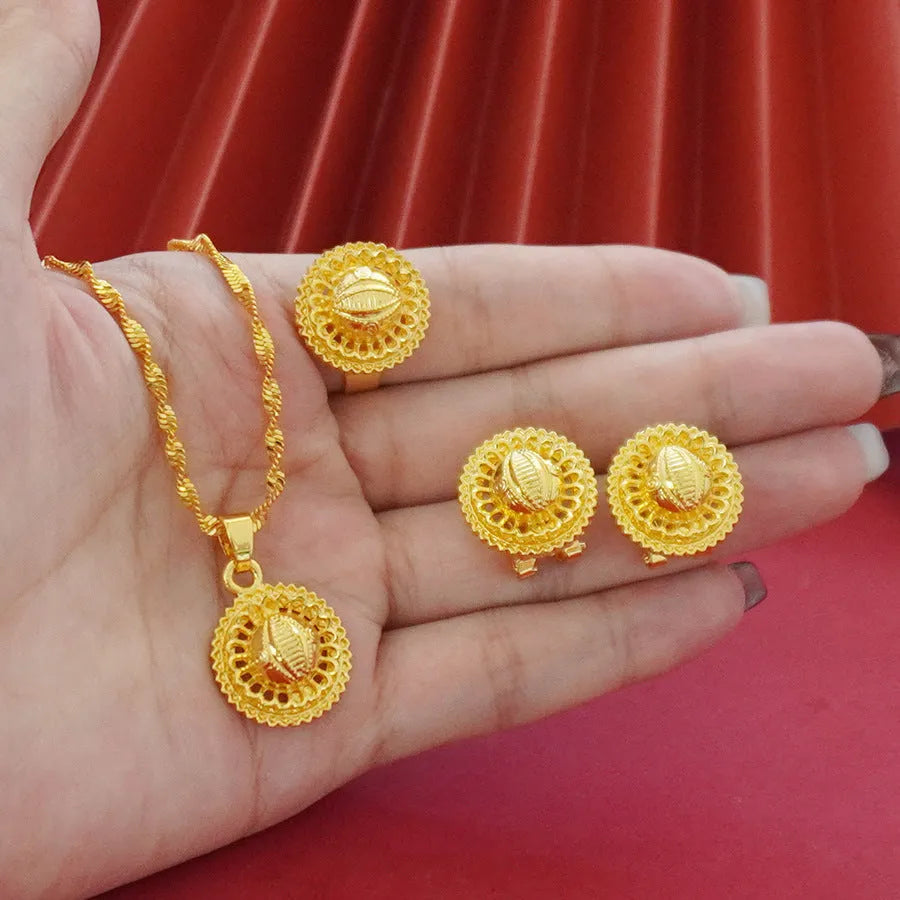 Gold-plated three-piece jewellery set with a three-layer flower design necklace, matching earrings, and ring on a white background.
