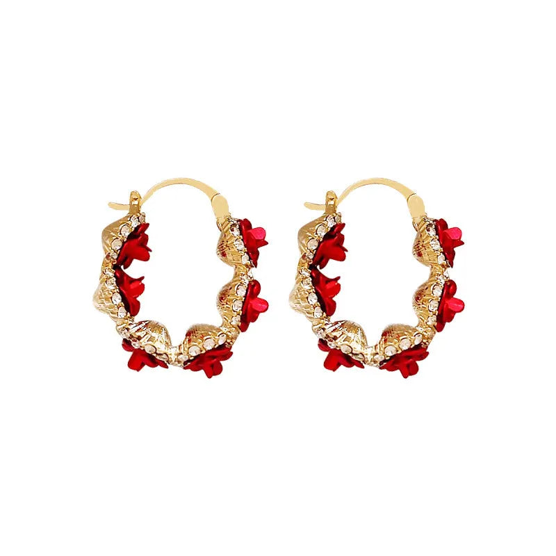Red alloy rose flower earrings with ear clip fastening shown as complete pair