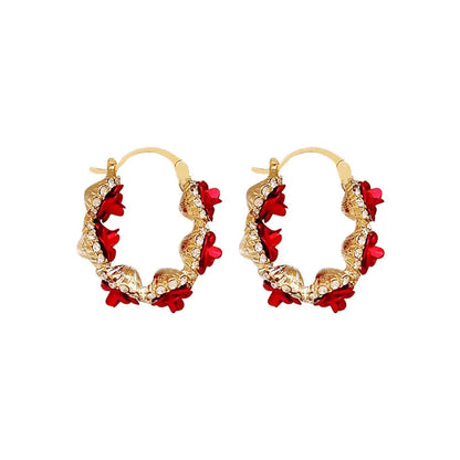 Red alloy rose flower earrings with ear clip fastening shown as complete pair
