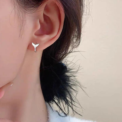 A pair of women's simple fishtail drop earrings with a gold electroplated finish on a copper base.