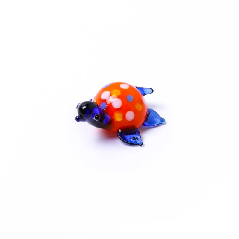Geometric glass turtle figurine ornament on a desk, shown in blue head and blue shell colour variant.