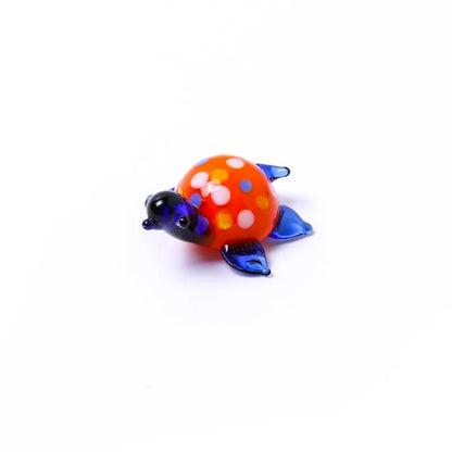 Geometric glass turtle figurine ornament on a desk, shown in blue head and blue shell colour variant.