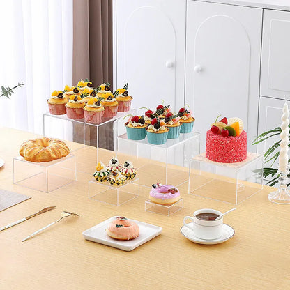 Six acrylic cubes in graduated sizes 3-8cm for dessert display, available in transparent or white